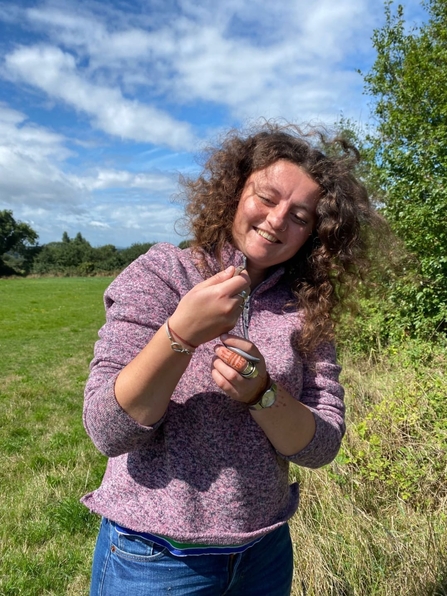 A photo of Grace holding a slow worm 