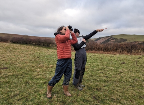 Trainees looking through Binoculars